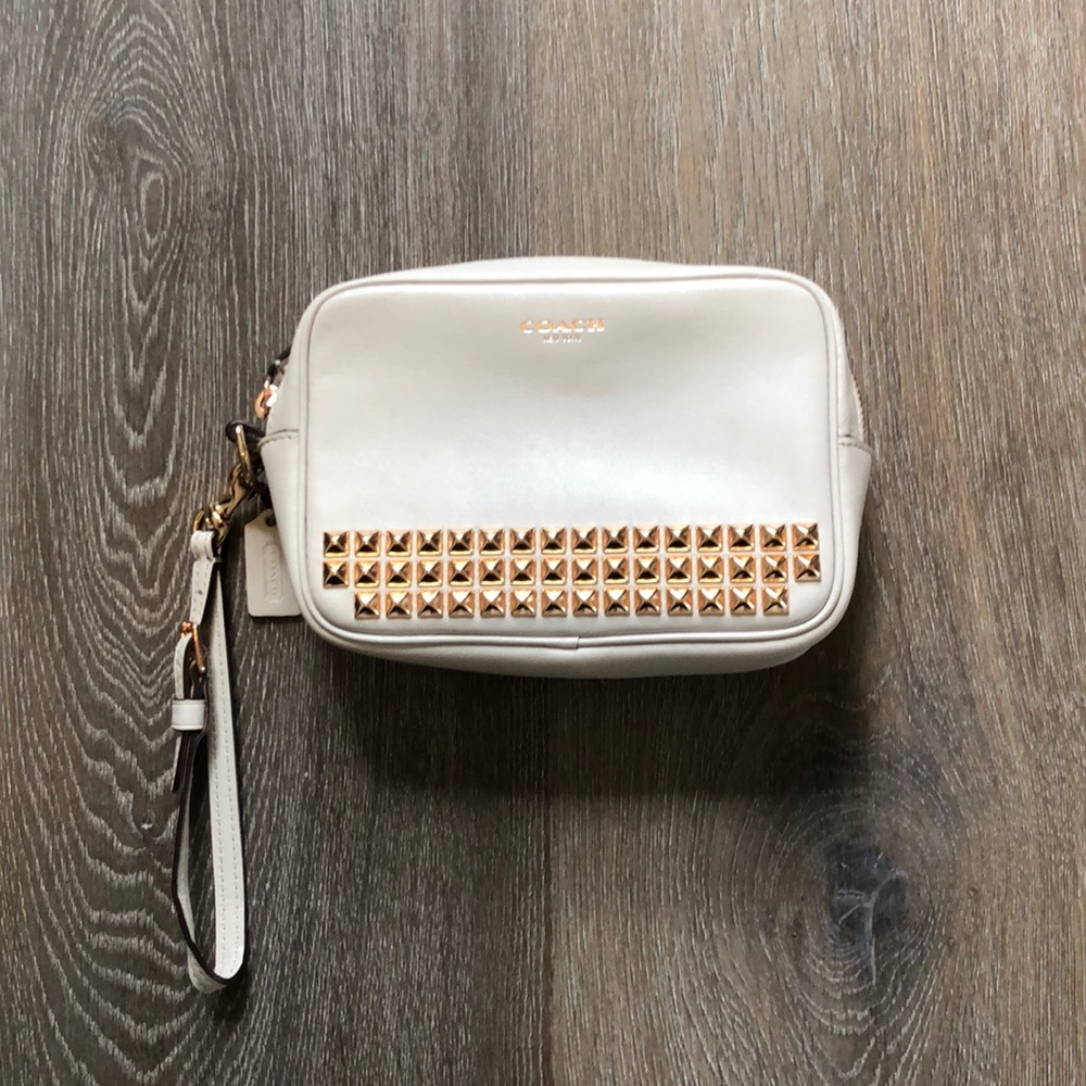 Coach rose gold and beige studded wristlet